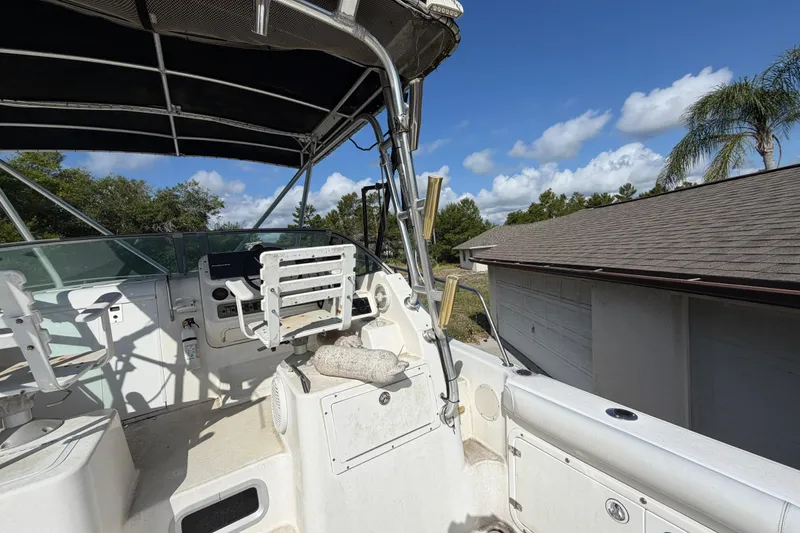 Slide: The Image of Century 3200 Walk-Around boat interior, 2000 model, with helm and seating under canopy. - 80