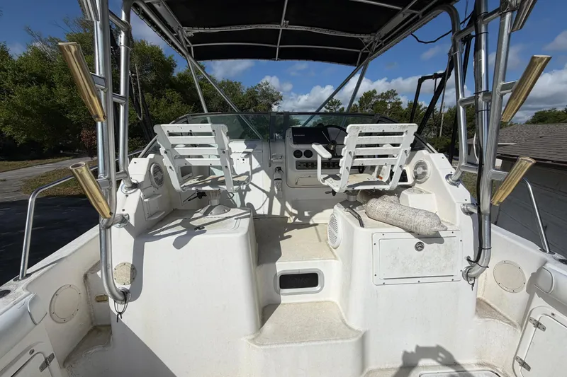 Slide: The Image of 2000 Century 3200 Walk-Around boat cockpit with seating and steering console. - 82