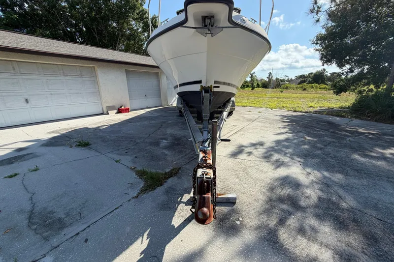 Slide: The Image of 2000 Century 3200 Walk-Around boat on trailer in driveway, sunny day. - 9