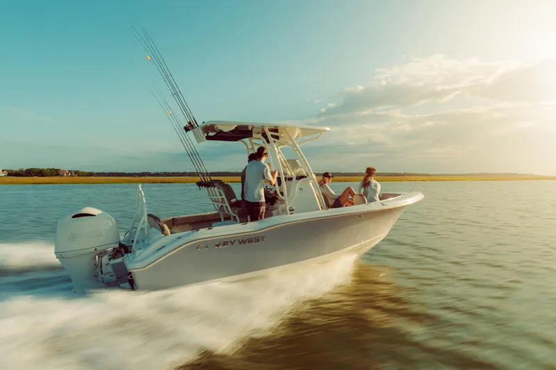 Slide: The Image of 2026 Key West 239 FS boat cruising on serene water at sunset. - 8