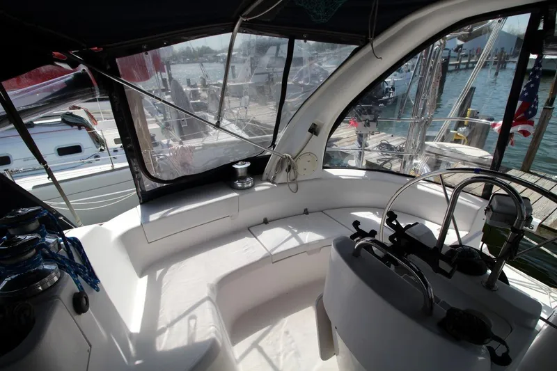 Slide: The Image of Interior view of a 1999 Hunter 410 sailboat cockpit at a marina. - 12
