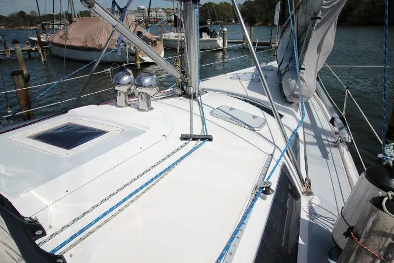 Slide: The Image of Sailboat deck of 1999 Hunter 410 model, docked at marina with rigging and equipment. - 13