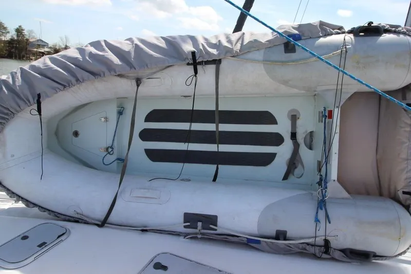 Slide: The Image of Inflatable boat on deck of 1999 Hunter 410 sailboat, secured with ropes. - 15