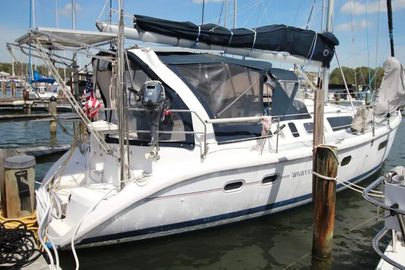 Slide: The Image of Sailboat Hunter 410, 1999 model, docked at marina with covered cockpit. - 2