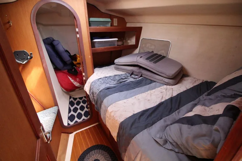 Slide: The Image of Cozy cabin interior of 1999 Hunter 410 sailboat with bed and storage. - 20