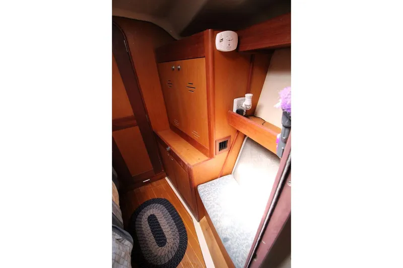 Slide: The Image of Interior cabin of 1999 Hunter 410 sailboat with wooden cabinetry and seating area. - 22