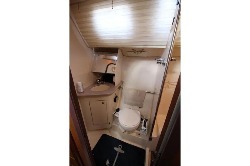 Slide: The Image of Bathroom interior of a 1999 Hunter 410 yacht, featuring a compact design. - 25