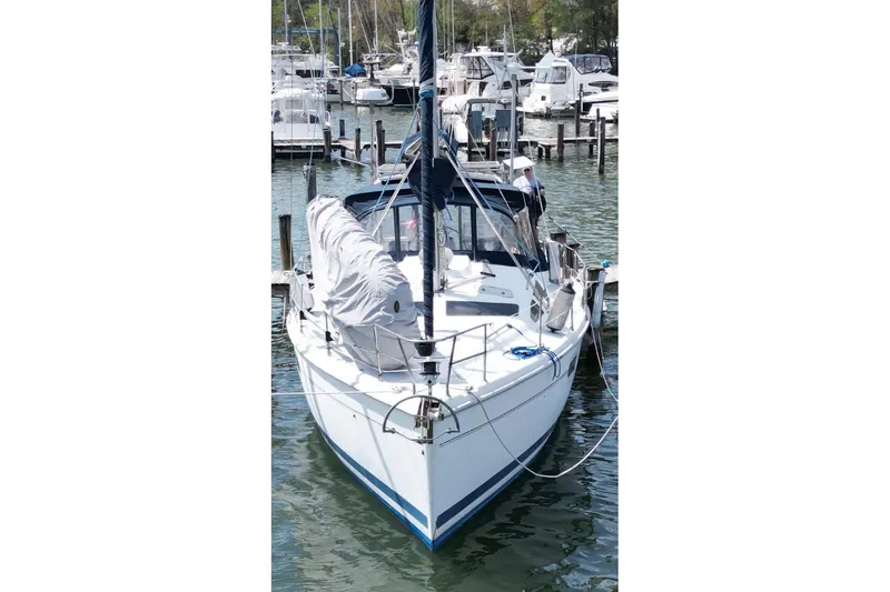 Slide: The Image of Sailboat docked in marina, 1999 Hunter 410 model, surrounded by other boats. - 5