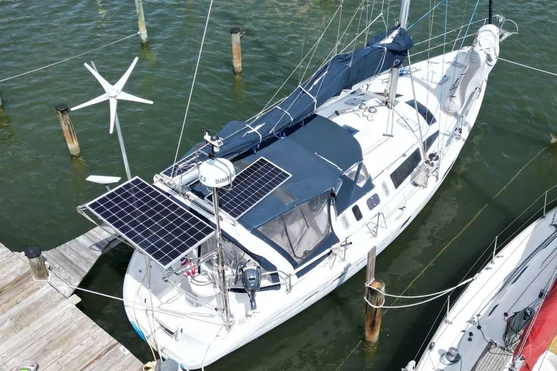 Slide: The Image of Sailboat with solar panels and wind turbine, Hunter 410, 1999 model, docked in marina. - 6