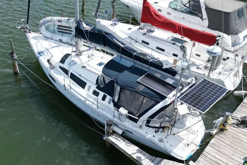 Slide: The Image of Sailboat Hunter 410, 1999 model, docked with solar panels on deck. - 7