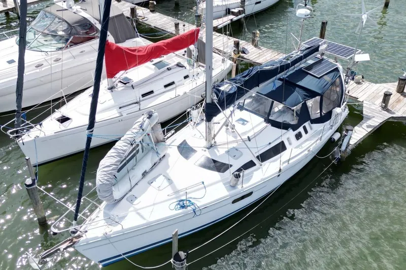 Slide: The Image of Sailboat Hunter 410, 1999 model, docked at marina with solar panels. - 8