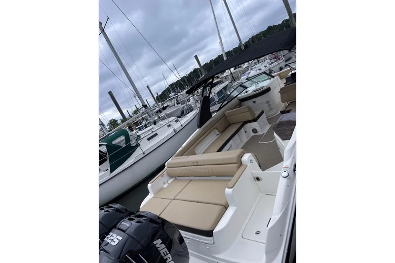 Slide: The Image of 2018 Sea Ray SDX 290 Outboard boat docked, featuring spacious seating and twin Mercury engines. - 11