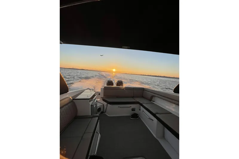 Slide: The Image of 2018 Sea Ray SDX 290 Outboard cruising at sunset, with scenic ocean view. - 14