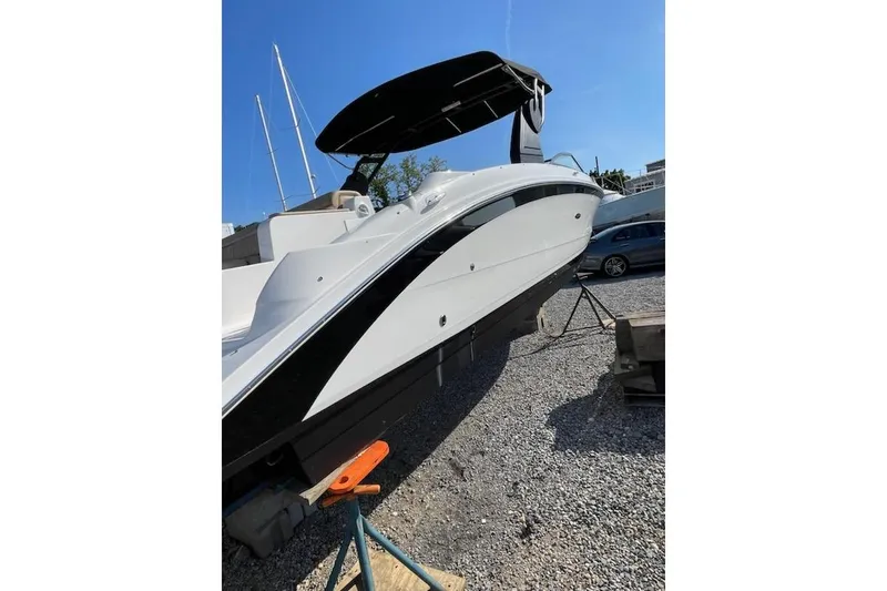 Slide: The Image of 2018 Sea Ray SDX 290 Outboard boat on dry dock, side view under clear blue sky. - 17