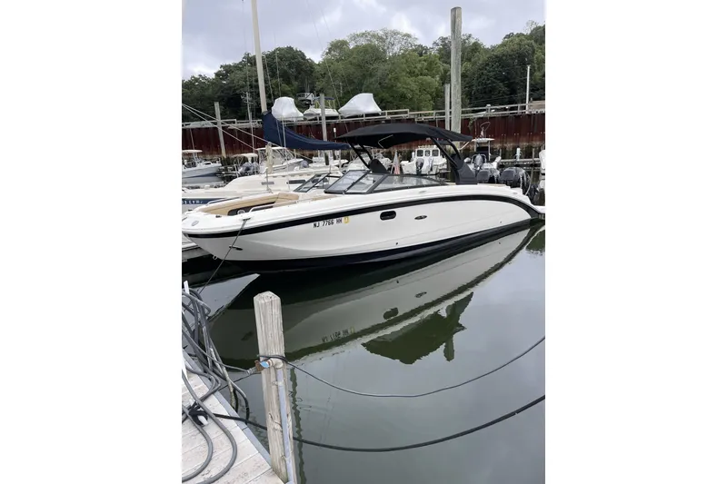 Slide: The Image of 2018 Sea Ray SDX 290 Outboard boat docked in a marina. - 2