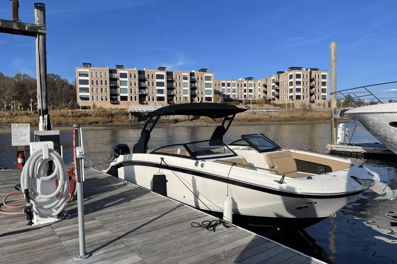 Slide: The Image of 2018 Sea Ray SDX 290 Outboard docked at marina with modern buildings in background. - 3