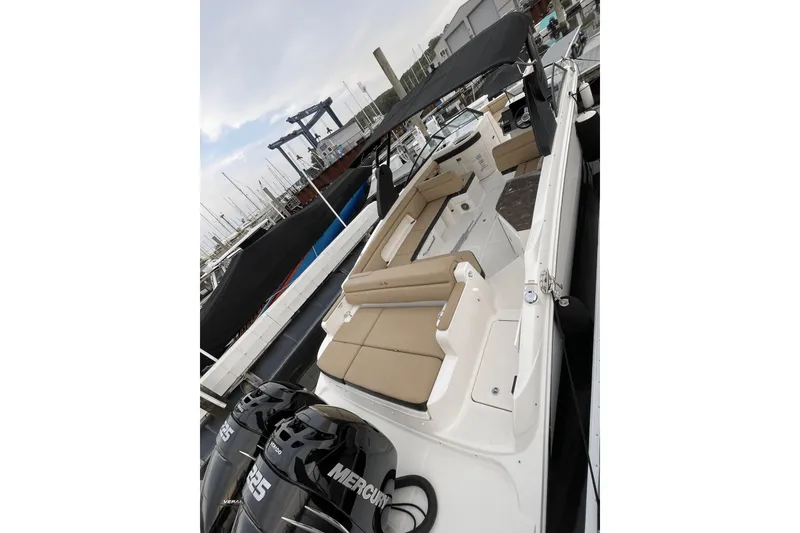 Slide: The Image of 2018 Sea Ray SDX 290 Outboard boat with beige seating at a marina. - 4