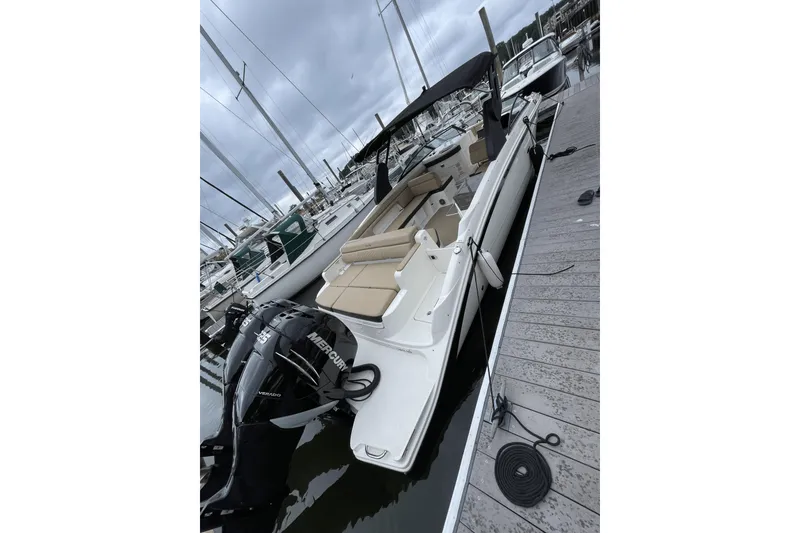 Slide: The Image of 2018 Sea Ray SDX 290 Outboard boat docked at marina, featuring spacious seating. - 8