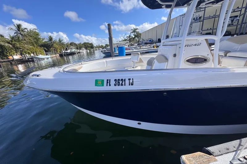 Slide: The Image of 2020 Robalo R242 Explorer boat docked in sunny marina setting. - 10