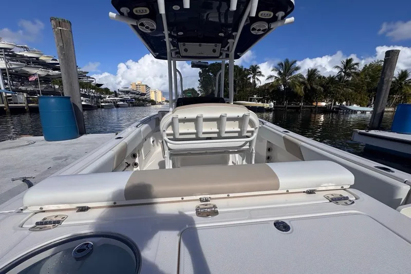 Slide: The Image of 2020 Robalo R242 Explorer boat docked at marina with palm trees and blue sky. - 12