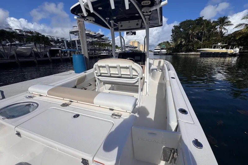 Slide: The Image of 2020 Robalo R242 Explorer boat docked at marina, featuring spacious seating and sleek design. - 13