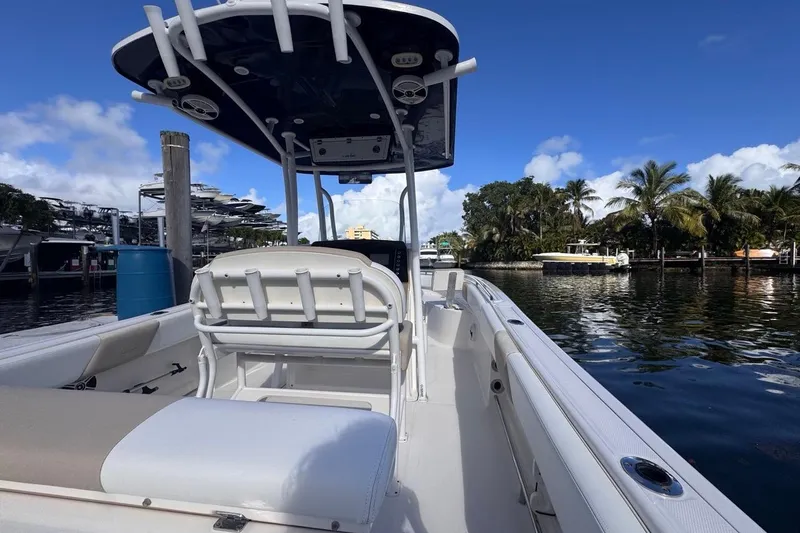 Slide: The Image of 2020 Robalo R242 Explorer boat docked by palm trees under blue sky. - 14