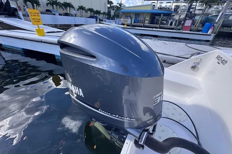 Slide: The Image of 2020 Robalo R242 Explorer with Yamaha outboard engine at marina dock. - 16