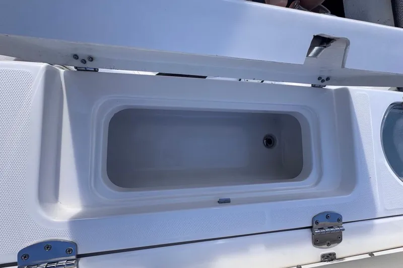 Slide: The Image of Open storage compartment on 2020 Robalo R242 Explorer boat. - 17