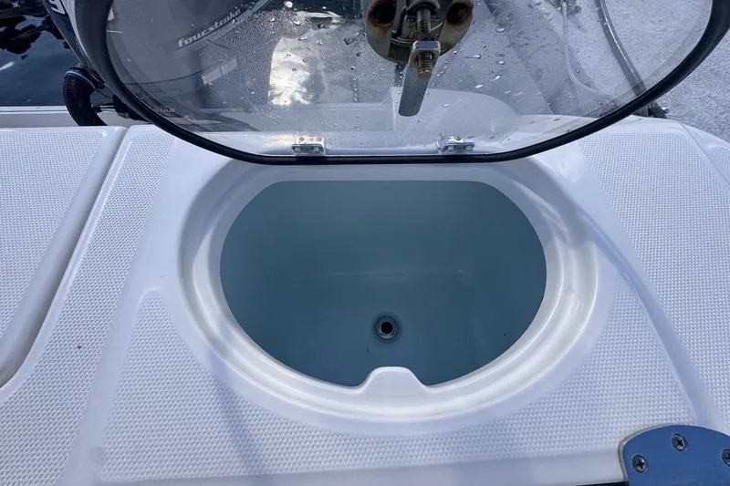Slide: The Image of Livewell compartment on a 2020 Robalo R242 Explorer boat, open lid view. - 19