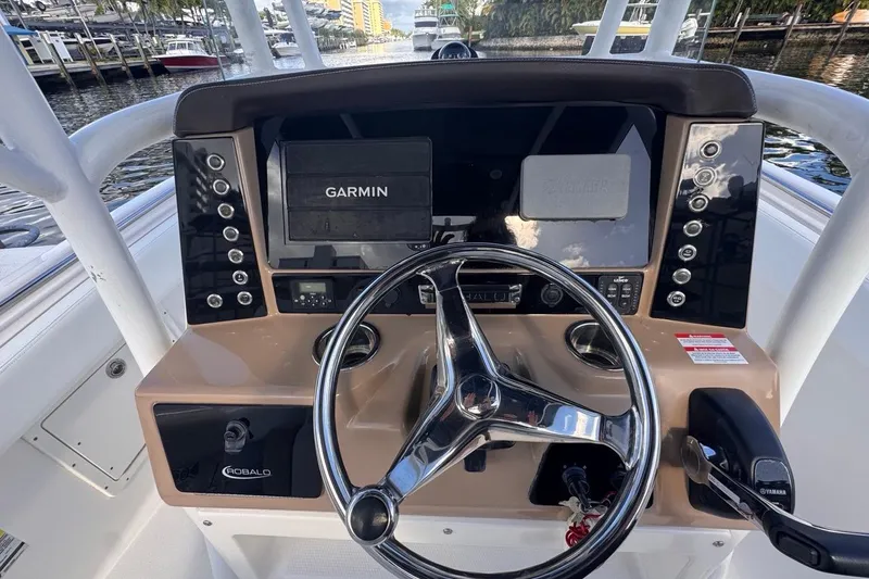 Slide: The Image of 2020 Robalo R242 Explorer boat dashboard with Garmin navigation system and steering wheel. - 24