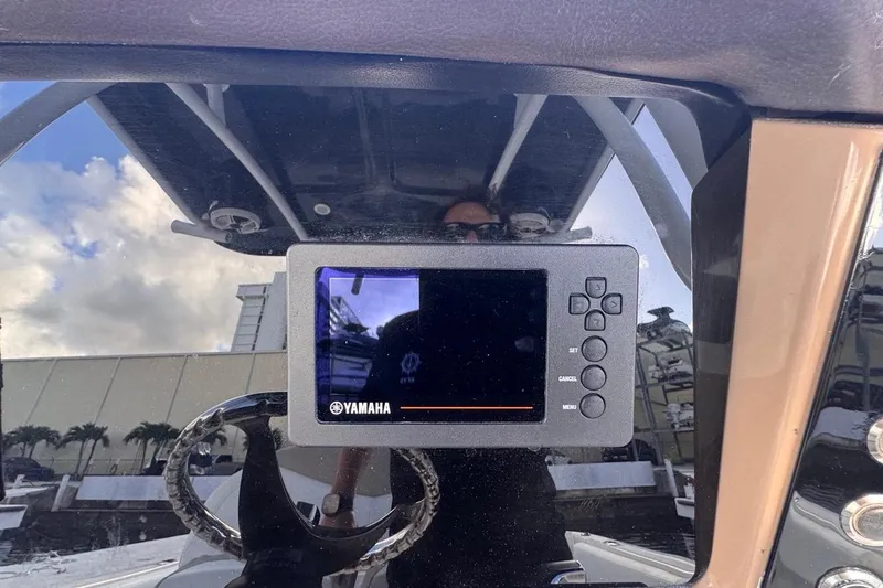 Slide: The Image of Yamaha display on 2020 Robalo R242 Explorer boat dashboard, reflecting sky and surroundings. - 25