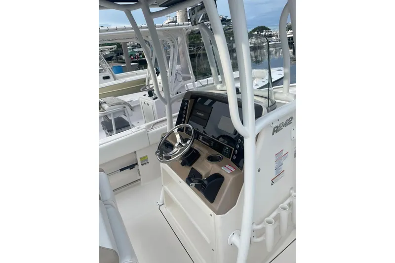 Slide: The Image of 2020 Robalo R242 Explorer boat console with steering wheel and navigation equipment. - 3