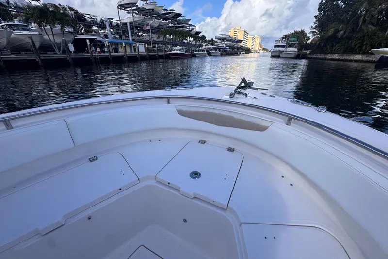 Slide: The Image of 2020 Robalo R242 Explorer boat docked in a marina with surrounding yachts. - 32