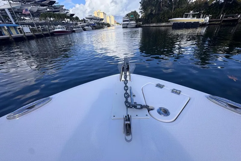 Slide: The Image of Bow view of 2020 Robalo R242 Explorer boat docked in a scenic marina. - 33