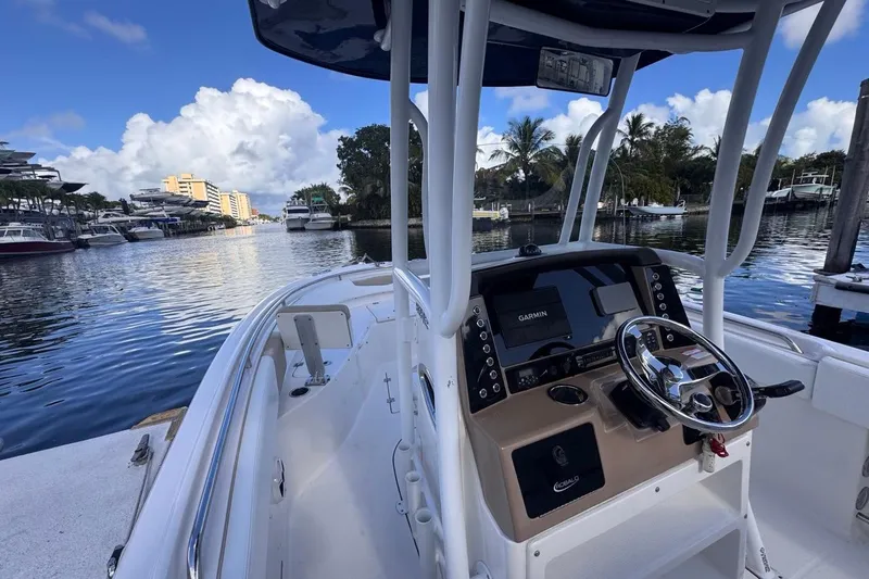 Slide: The Image of 2020 Robalo R242 Explorer boat with Garmin navigation, docked in a scenic marina. - 34