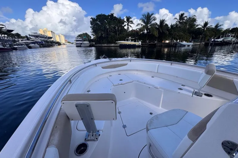 Slide: The Image of 2020 Robalo R242 Explorer boat docked in a scenic marina with palm trees. - 35