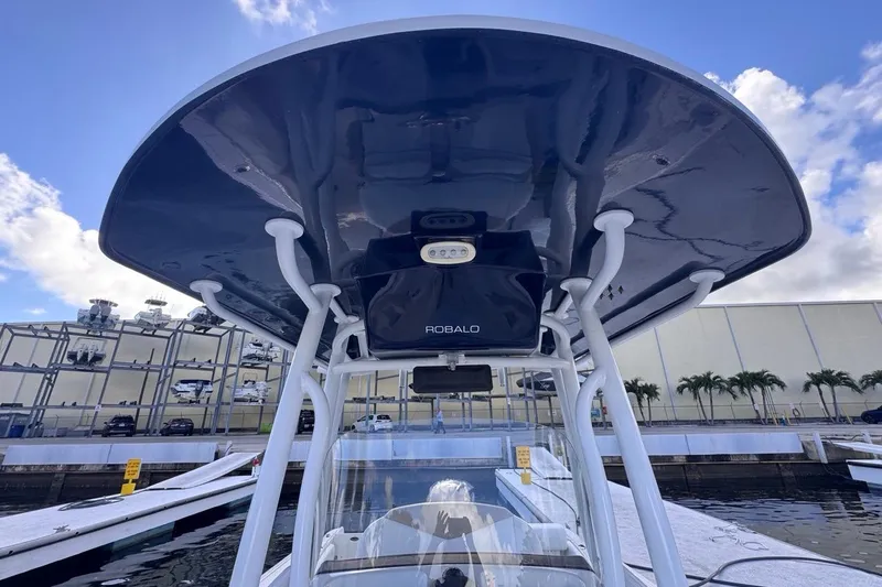 Slide: The Image of 2020 Robalo R242 Explorer boat with T-top at marina, clear sky background. - 38