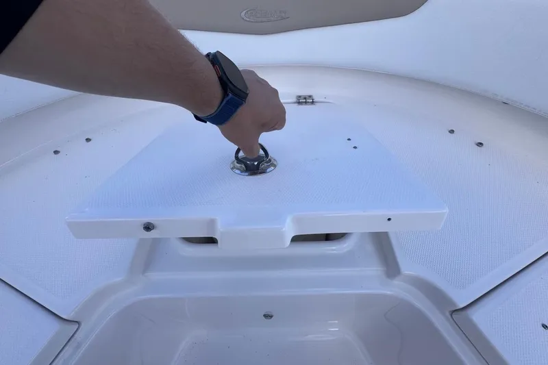 Slide: The Image of Hand operating hatch on 2020 Robalo R242 Explorer boat deck. - 40