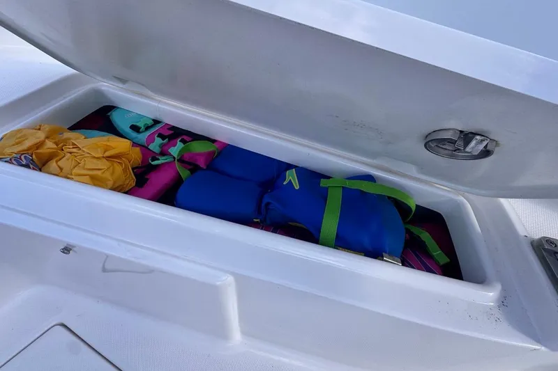 Slide: The Image of Storage compartment on 2020 Robalo R242 Explorer boat with life jackets and gear. - 41