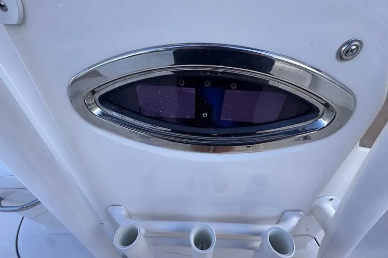 Slide: The Image of 2020 Robalo R242 Explorer boat detail with chrome trim and rod holders. - 43