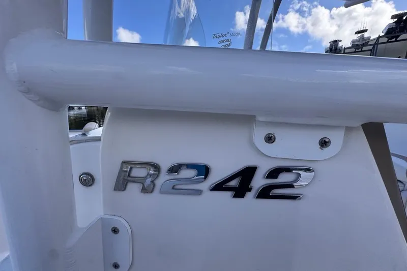 Slide: The Image of 2020 Robalo R242 Explorer boat emblem against a clear blue sky. - 44