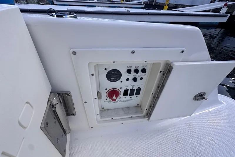 Slide: The Image of Control panel on a 2020 Robalo R242 Explorer boat, featuring various switches and dials. - 46