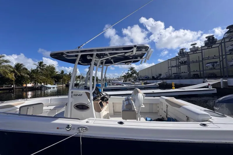 Slide: The Image of 2020 Robalo R242 Explorer boat docked under clear blue sky. - 8