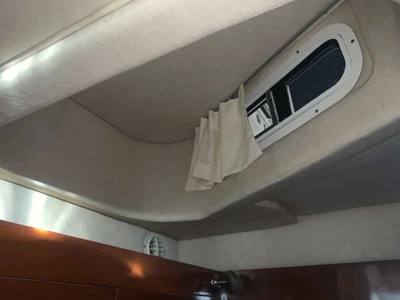 Slide: The Image of Interior cabin of 2009 Sea Ray 270 Sundancer with window and curtain. - 15