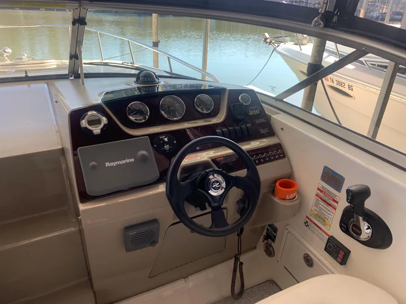 Slide: The Image of 2009 Sea Ray 270 Sundancer helm with steering wheel and navigation instruments. - 5