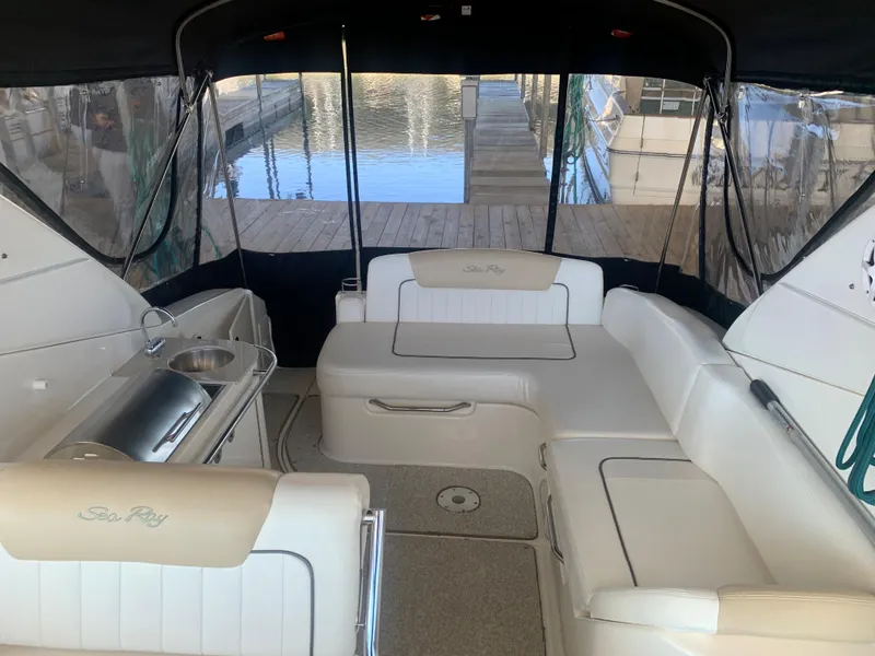 Slide: The Image of 2009 Sea Ray 270 Sundancer interior with seating and kitchenette, docked at marina. - 9