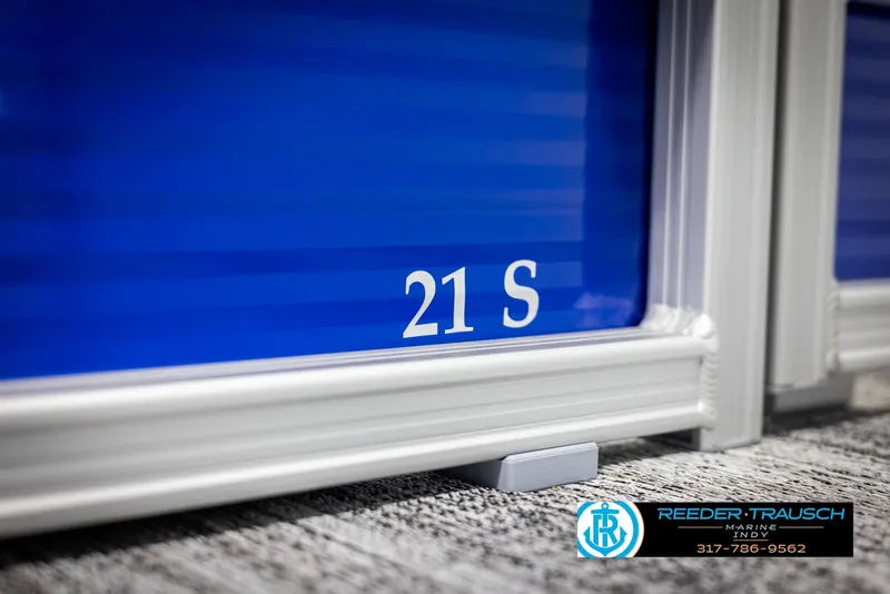 Slide: The Image of Close-up of Bennington 21 SSR 2025 boat with blue paneling. - 41