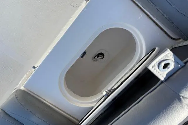 Slide: The Image of 2022 NauticStar 2102 Legacy boat interior with built-in storage compartment. - 11