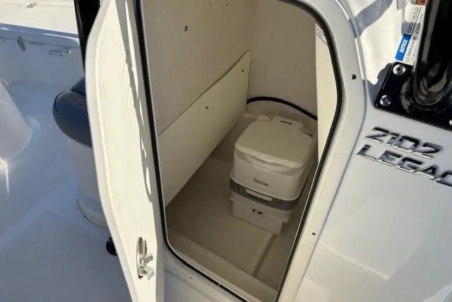 Slide: The Image of Portable toilet inside 2022 NauticStar 2102 Legacy boat compartment. - 12