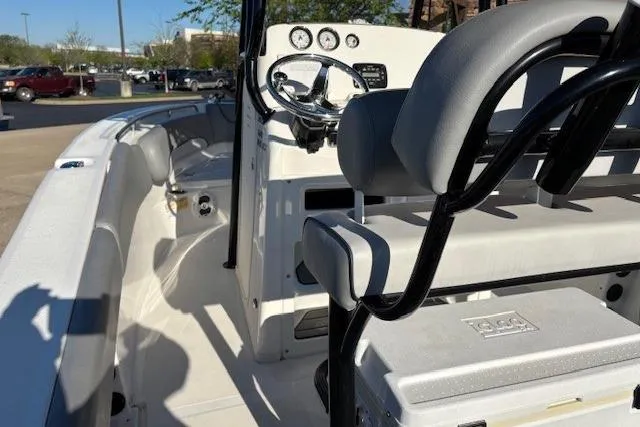 Slide: The Image of 2022 NauticStar 2102 Legacy boat interior with steering wheel and seating. - 13